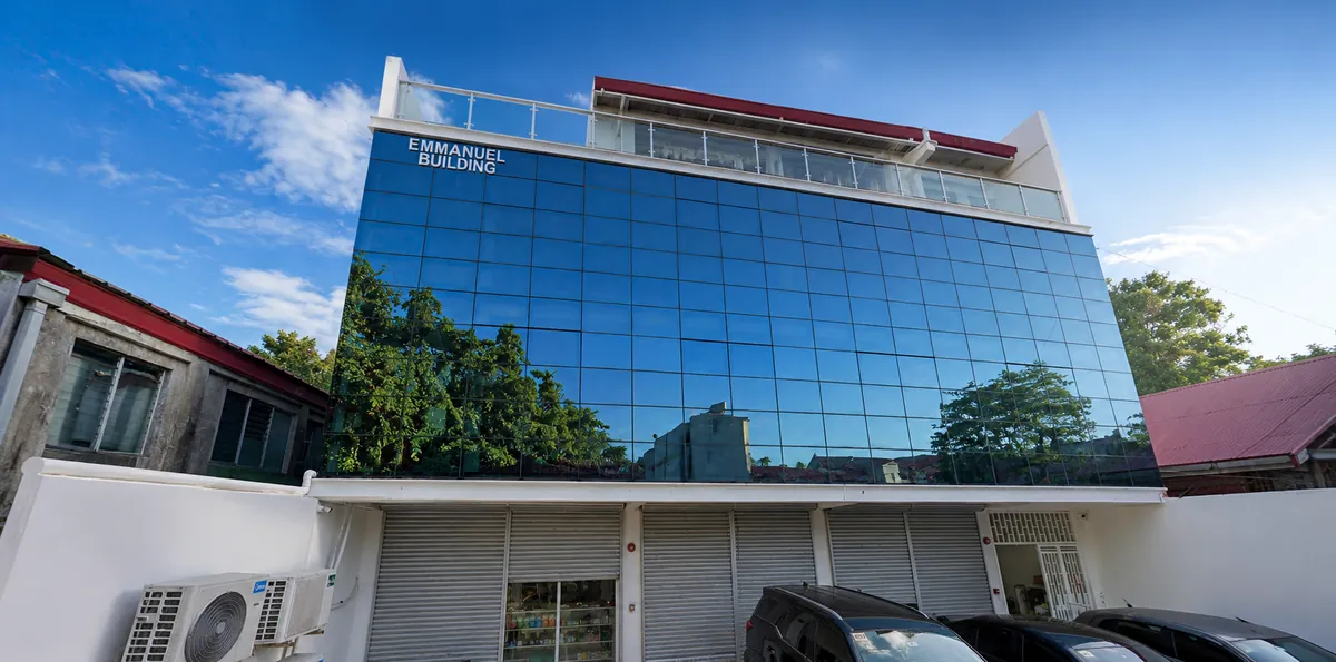 The Emmanuel Building on Claudio Lopez St., Jaro, Iloilo City — a glass-fronted office block.